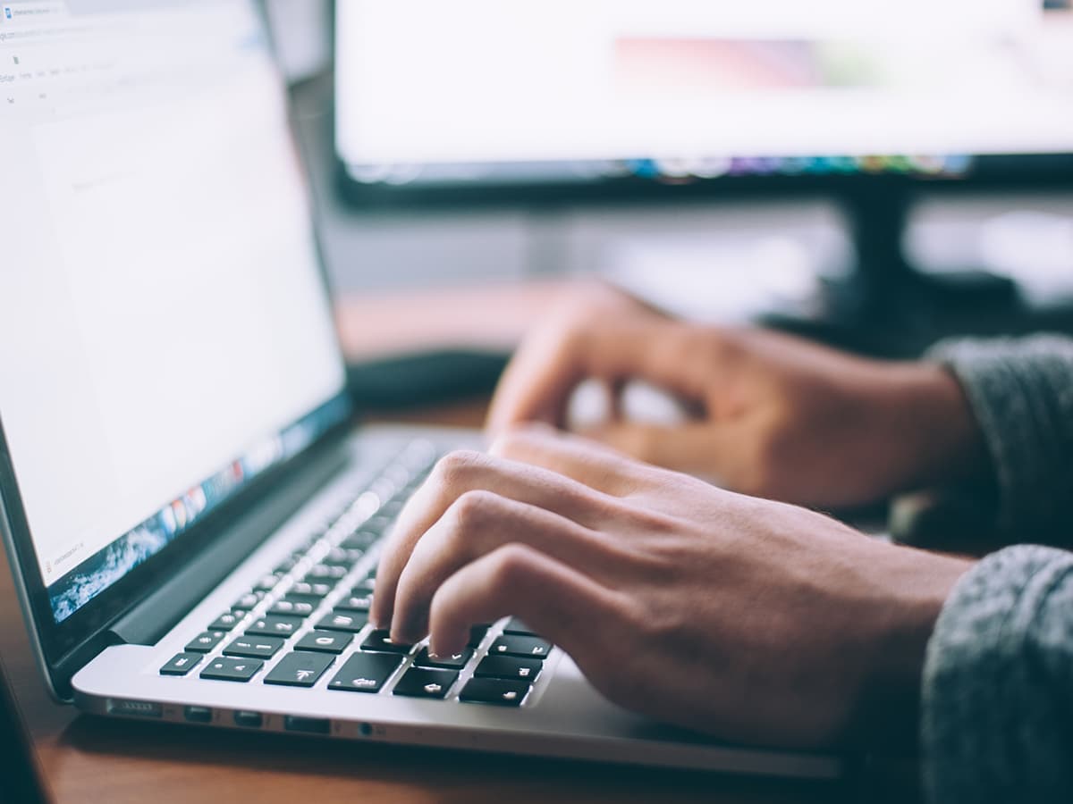 Man typing on a laptop